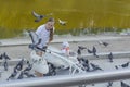 Russia Kaliningrad 2019 girl with child feeding pigeons with it