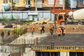 RUSSIA, KALUGA - AUGUST 15, 2022 : Concrete automatic pump tube working on construction site. Workers directing and Royalty Free Stock Photo