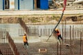 RUSSIA, KALUGA - AUGUST 15, 2022 : Concrete automatic pump tube working on construction site. Workers directing and Royalty Free Stock Photo