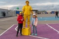 Russia, Kazan - August 27, 2019: Portrait of a smiling fans: Two adorable Russian white kid girls with animators with the logo of