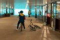 Russia, Kazan - August 8, 2019: Stylish teenager boy on a bicycle with a phone in his hands listens to a voice message in a subway