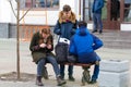 RUSSIA, KAZAN 10-04-2019: Urban streets. Teenagers sitting on the bench