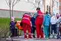 Russia Kemerovo 2019-05-21 Ambulance team of woman in red uniform helping child sitting on bench on the street near