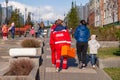Russia Kemerovo 2019-05-21 Ambulance team of a woman in a red uniform with an orange medicine case is walking down the