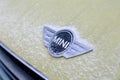 Russia Kemerovo 2019-01-07 Close view of Mini Cooper car logo badge on yellow Mini Cooper car covered snow Royalty Free Stock Photo