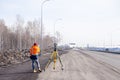 Russia Kemerovo 2019-03-15. Land and construction surveyor equipment. Geodesist controls robotic total station theodolite.