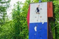 Russia Kemerovo 1.06.2020 Little girl climbing on artificial boulders wall