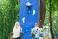 Russia Kemerovo 1.06.2020 Parents watch as a little girl climbing a wall of artificial boulders Royalty Free Stock Photo