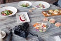 Russia Kemerovo 2019-03-10 professional camera Canon 5D Mark IV and many different dishes, fish, salads on table in restaurant. Royalty Free Stock Photo