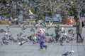 Russia, Khabarovsk, Lenin square: Children play with pigeons