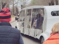 Russia, Kislovodsk 02.11.2021. An electric car with tourists drives along the road in the autumn park. Sightseeing in