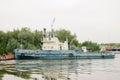 08/21/2021 Russia, Kolomna. An old rusty barge sails by on the Moscow River in summer