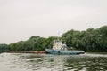 08/21/2021 Russia, Kolomna. An old rusty barge sails by on the Moscow River in summer