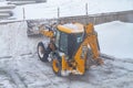 02 06 2022 Russia Kostroma Orange Bulldozer for clearing snow cleans snow on the road in winter