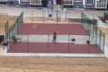 Russia Kostroma 10 10 2021 Workers install a rubber coating on a small mini football field, a sports field in the yard