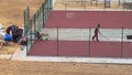 Russia Kostroma 10 10 2021 Workers install a rubber coating on a small mini football field, a sports field in the yard