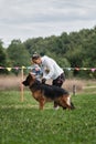 4.09.21 Russia Krasnodar dog show of the German Shepherd breed. Female handler is trying to correctly place long haired German