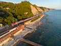 A bird`s-eye view of Gizel-Dere railway station and passing train along the Black Sea coast on a warm summer evening Royalty Free Stock Photo