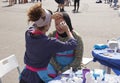 Russia, Krasnoyarsk, July 2019: Young teenage girls have fun doing makeup, using lip gloss, brush, perfume