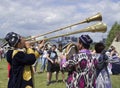 Uzbeks play long brass musical instruments