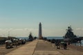 Russia. Kronstadt. May 22, 2019. The mooring wall of the Petrovsky dock of the sluice canal and the lighthouse on it.