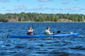 Russia, Lake Ladoga, August 2020. Girls in a kayak on the wide expanses of the lake.