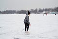 Russia Lobnya december 18 2020. A girl rides on an icy river in white skates editorial