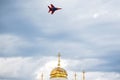 Russia, Magnitogorsk, - July, 19, 2019. Russian Fulcrum-A fighter plane MiG 29 over the dome of an Orthodox church