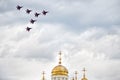 Russia, Magnitogorsk, - July, 19, 2019. Six Russian Fulcrum-A MiG 29 attack aircraft over the dome of an Orthodox church