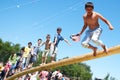 Russia, Magnitogorsk, - June, 16, 2011. Boys play national games, jump on a log, during Sabantuy - the national holiday of the