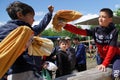 Russia, Magnitogorsk, - June, 15, 2019. Central Asian traditional active game - fight with bags on a log during the holiday