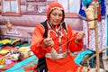 Russia, Magnitogorsk, - June, 15, 2019. A woman with a spindle demonstrates the work of a manual spinning wheel during the holiday