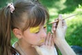 Russia 06-23-2018 Master body art puts the girl drawing paints on face