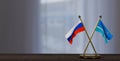 Russia and Midway Islands flags on table.