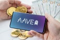 Russia Moscow 20.05.2021 AAVE logo in mobile phone. Open Source Liquidity DEX Protocol. Cryptocurrency decentralized exchange.