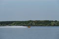 Russia, Moscow - August 2022. Person riding fast jet ski skimming surface of Lake. Male lifeguard in life jacket fast on water Royalty Free Stock Photo