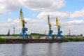 Russia, Moscow August 2018: Unloading of the barge with crushed stone port cranes in the port