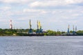 Russia, Moscow August 2018: Unloading of the barge with crushed stone port cranes in the port