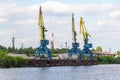 Russia, Moscow August 2018: Unloading of the barge with crushed stone port cranes in the port