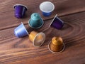 10.03.2021 Russia, Moscow. Bright multi-colored capsules with Nespresso coffee on a brown wooden background. Close up, side view Royalty Free Stock Photo