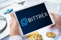 Russia Moscow 05.05.2021.Businessman holding tablet with logo of cryptocurrency stock exchange Bittrex. Buy,sell,change crypto