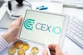 Russia Moscow 05.05.2021.Businessman holding tablet with logo of cryptocurrency stock exchange Cex.io. Buy,sell,change crypto