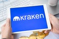 Russia Moscow 05.05.2021.Businessman holding tablet with logo of cryptocurrency stock exchange Kraken. Buy,sell,change crypto