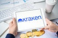 Russia Moscow 05.05.2021.Businessman holding tablet with logo of cryptocurrency stock exchange Kraken. Buy,sell,change crypto
