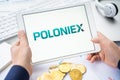 Russia Moscow 05.05.2021.Businessman holding tablet with logo of cryptocurrency stock exchange Poloniex.Buy,sell,change crypto