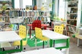 Russia Moscow 25.09.20 Children`s city library. Special reading room for kids with bright green, red, yellow tables, chairs. Many Royalty Free Stock Photo