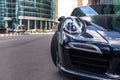 Russia Moscow 2019-06-17 Closeup headlights of new shiny luxury dark blue sports car Porsche 911 parked on street, front bottom