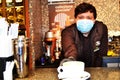 Russia Moscow December 20 2020. Young barista guy in medical mask serves coffee editorial