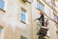 22.05.2019 Russia, Moscow. The employee of municipal services washes a facade of the multi-storey building by means of the high-