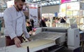 03.14.2019 Russia, Moscow. Exhibition Modern Bakery Moscow. the chef rolls the dough using a production machine. Selected focus.